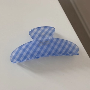 Detail of blue and white gingham hair claw clip with Barrette La France text