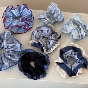 Detail of 6-piece blue plaid scrunchie set with lace edges and floral patterns