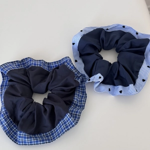 Close-up of blue plaid and heart pattern fabric scrunchies for hair styling