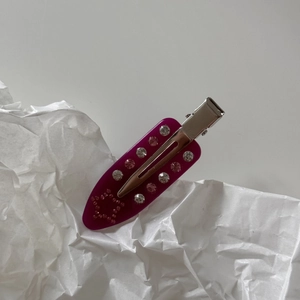 Detailed view of a purple marble acetate duckbill clip with pink rhinestone star pattern