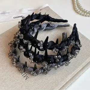 Luxurious braided headband with rhinestones and punk studs in black and grey finish