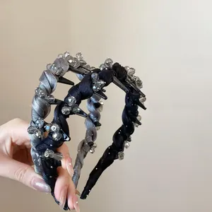 Detailed view of woven rhinestone headbands with integrated side hair clips in dark grey