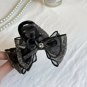 Elegant black mesh bow hair claw clip with rhinestones and central crystal for women