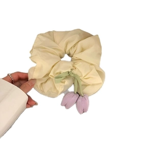 Floral tulip scrunchie with streamers and purple flower charms for elegant ponytails