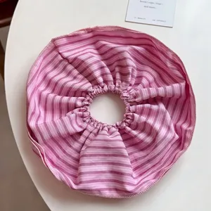 Detail of pink striped scrunchie showing fabric texture and neat double-layered edges