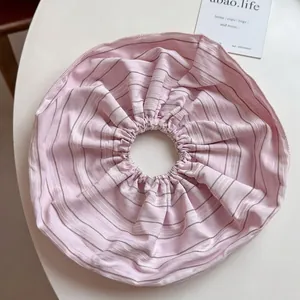 Detail of pink striped scrunchie with elastic ruffled fabric and soft texture