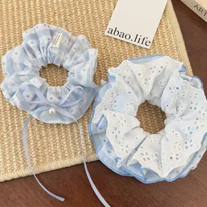 Blue lace scrunchie set with polka dots, ribbon bows, and pearl charms for hair