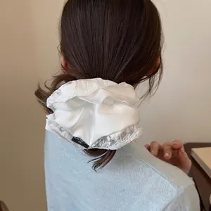 Elegant silk texture scrunchie with lace trim and Blind for Love woven label