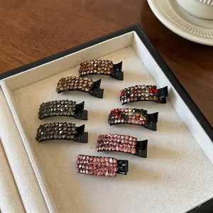 Exquisite sparkling rhinestone duckbill hair clips in eight colors on a display tray