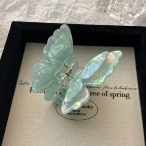 Detail view of the iridescent pearlescent butterfly hair claw with double-layer wings design