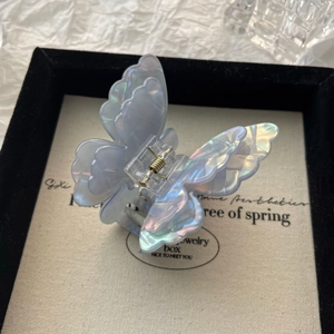 Detailed macro view of the double-layer iridescent butterfly hair claw clip with pearl luster