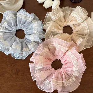 Three-pack set of lace scrunchies in pink, blue, and white with elegant polka dot patterns