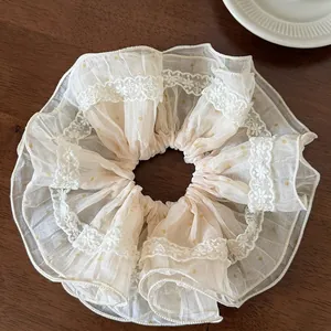 Detail of Korean style cream lace scrunchie with yellow polka dots and organza ruffles