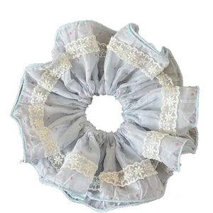 Sweet light blue scrunchie with pink polka dots and white lace edges for hair styling