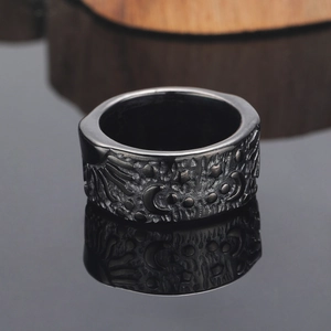 Gothic punk titanium steel ring with celestial moon and star relief on black reflective surface