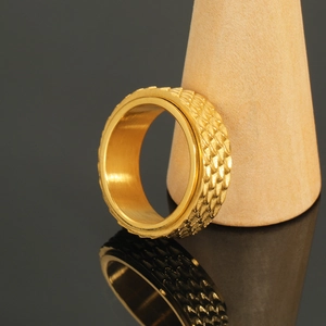 Detailed close-up of golden stainless steel spinner ring with dragon scale texture