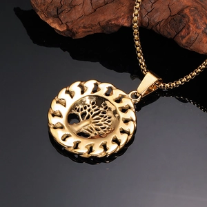 Macro detail of golden tree of life pendant with intricate cutout on a box chain