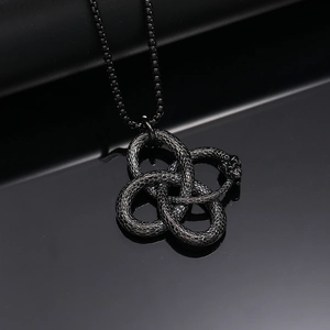 Macro detail of gothic ouroboros snake pendant with scales and a dark black finish