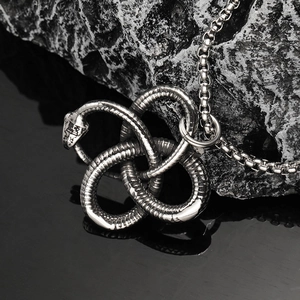 Gothic vintage stainless steel double snake necklace with detailed scales on black rock