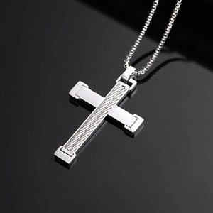 Polished silver titanium steel cross pendant necklace with inlaid steel wire on black reflection