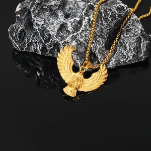 Men's punk eagle pendant necklace in gold finish with square pearl chain on dark rock