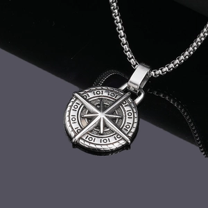 Macro shot of vintage silver compass pendant with 101 engraving and steel box chain