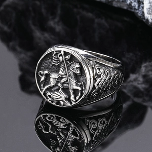 Macro view of vintage Saint George and the Dragon relief on a silver punk signet ring