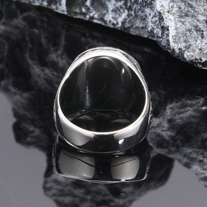 Macro side view of polished silver punk ring showing thick band and smooth metal texture