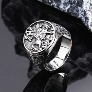 Macro shot of silver St. George slaying dragon relief on vintage punk signet ring