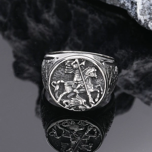 Detail of vintage silver Saint George slaying the dragon relief on men's punk signet ring