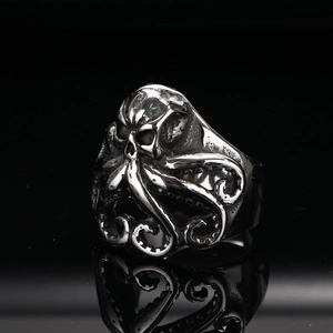 Macro shot of silver octopus tentacles and skull ring with detailed vintage suction cups