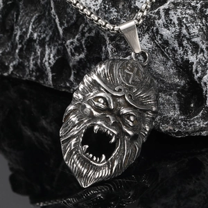 Gothic style silver monkey king pendant with heavy chain on black stone background