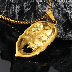 Macro shot of gold-plated hockey mask pendant with intricate metal texture and sturdy chain