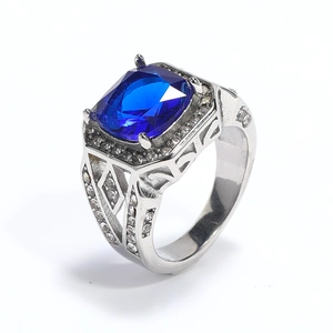 Macro shot of silver ring with large rectangular blue stone and hollow side details