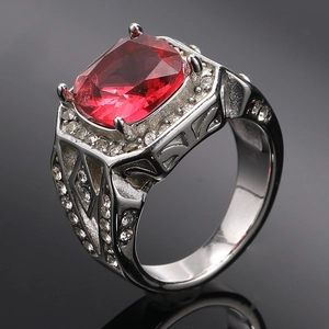 Detail view of large red rectangular gemstone set in four claws on a silver ring