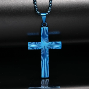 Détail du collier croix en acier titane bleu avec texture radiale sur fond noir pur