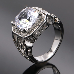Macro detail of silver titanium steel ring with four-claw set cubic zirconia and pavé accents