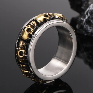 Detailed macro shot of vintage punk rocker skull ring with golden relief on silver steel