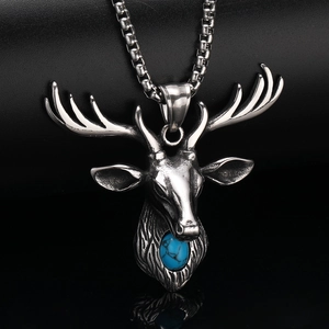 Macro shot of silver stainless steel stag head pendant with blue stone on black leather