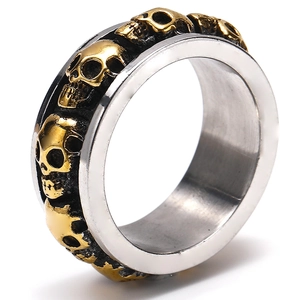Punk style stainless steel skull ring with silver band and gold skull relief accents
