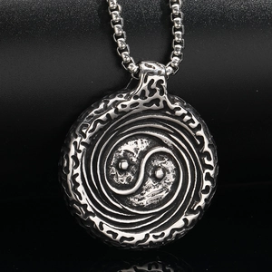 Macro shot of retro Yin Yang Tai Chi pendant in antique silver stainless steel