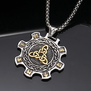 Detail of Viking gear pendant with gold Triquetra and engraved Runic symbols on box chain