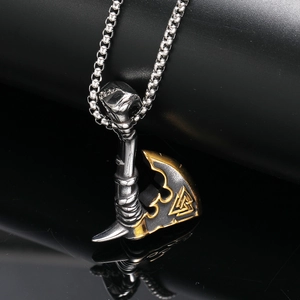 Macro shot of Viking axe pendant with Valknut symbol in silver and gold steel finish