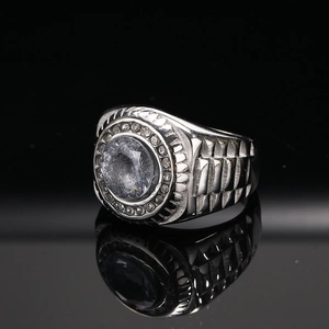 Macro-opname van zilveren titanium ring met groot kristal en geometrische zijtexturen