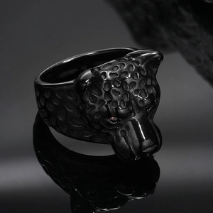 Detailed macro of a vintage leopard ring with red zircon eyes and black spot texture