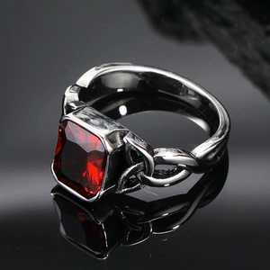 Macro detail of rectangle red gemstone set in a vintage Viking knot silver band