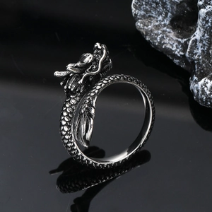 Macro detail of vintage silver dragon ring featuring intricate scales and punk style