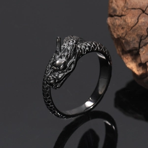 Macro shot of gun-black dragon ring with intricate scale texture and vintage details