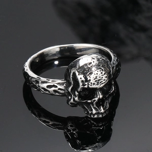 Macro shot of vintage skull ring with oxidized punk textures and gothic steel finish