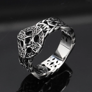Macro shot of Celtic knot ring with black zircon stone and vintage steel finish